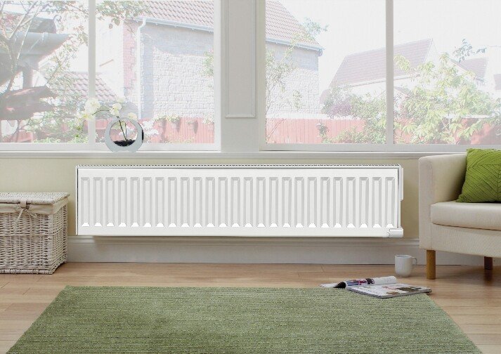 Conservatory showing wall mounted electric radiators with glass windows above